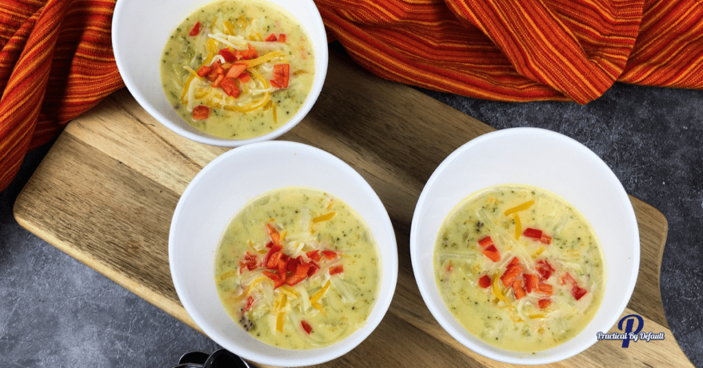 3 white bowls of broccoli cheese soup
