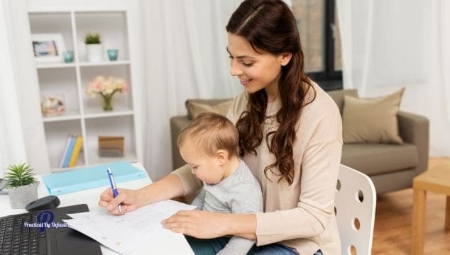 Mom working at home with young child on her lap
