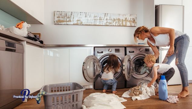 mom and kids tossing laundry in the machines