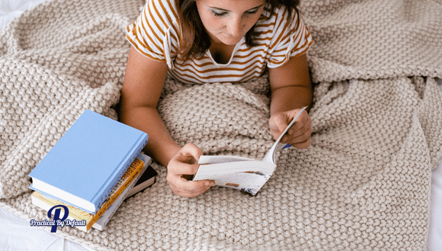 teen reading books quietly on the bed