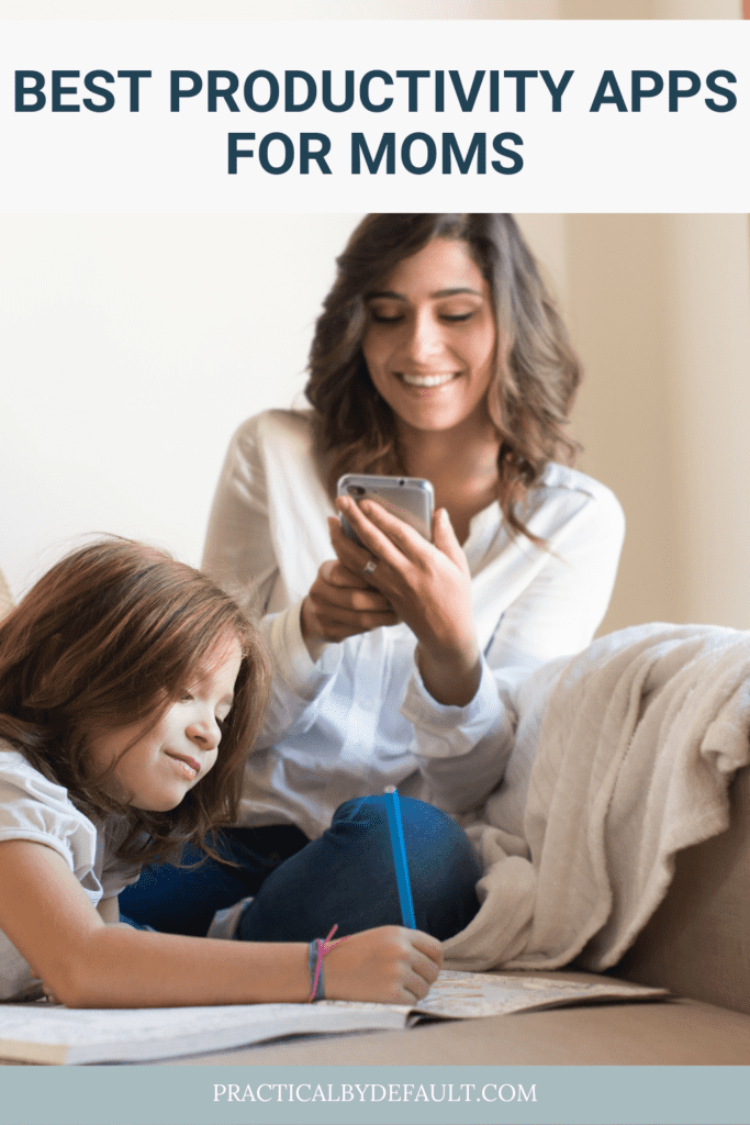 woman sitting using her phone while child plays